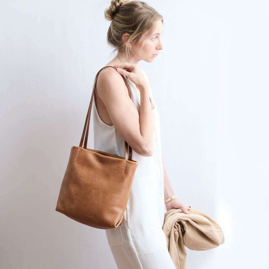 model wearing ballet tote on her shoulder 