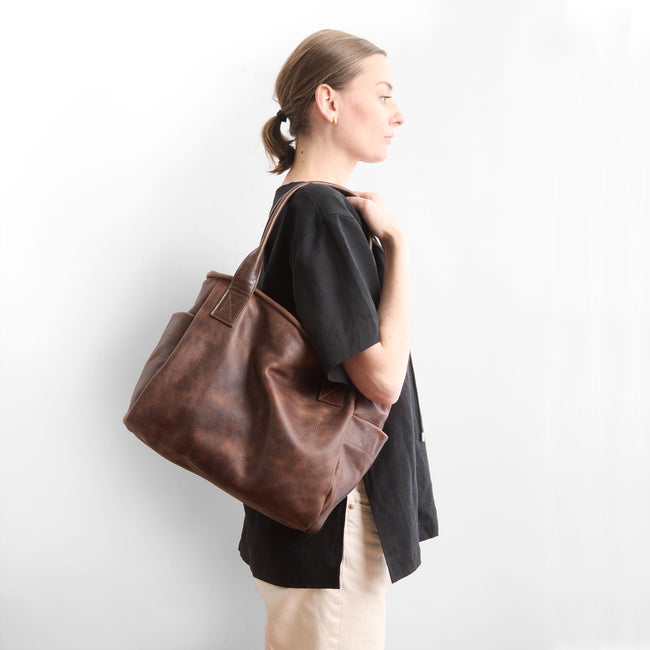 fuentes + cognac | model holding bucket tote in fuentes