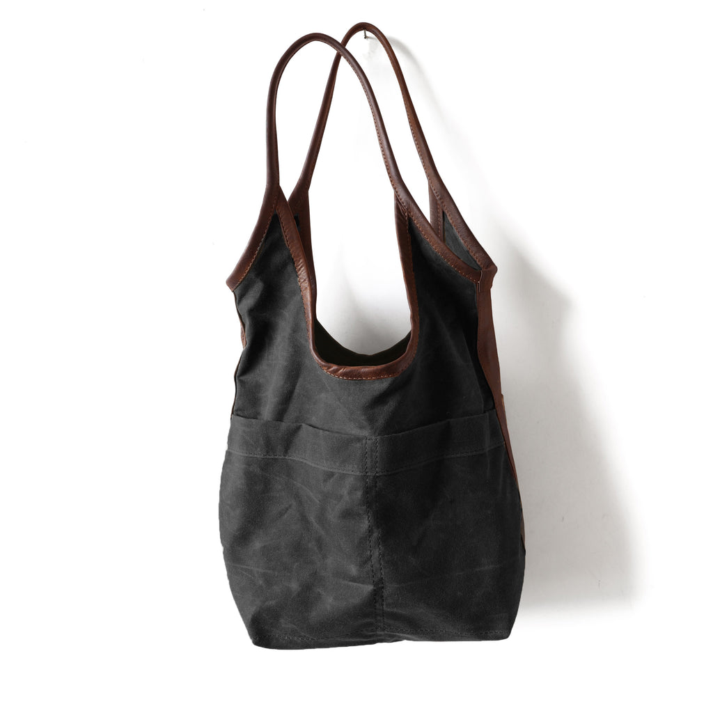 canvas sling size medium in black waxed canvas with fuentes strap
